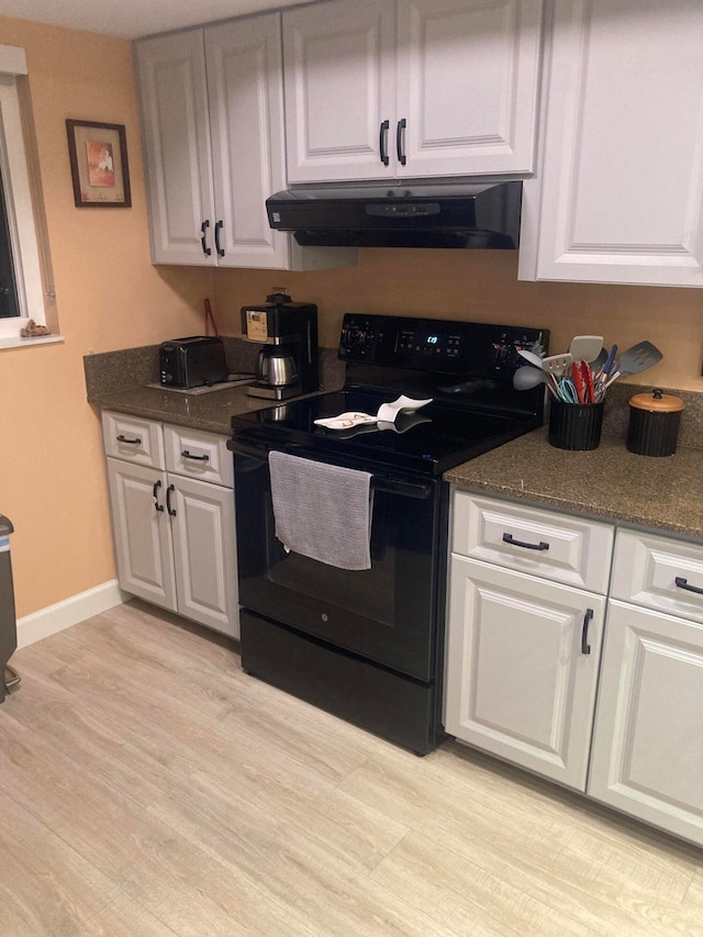 kitchen with light wood-type flooring, white cabinetry, electric range, and extractor fan