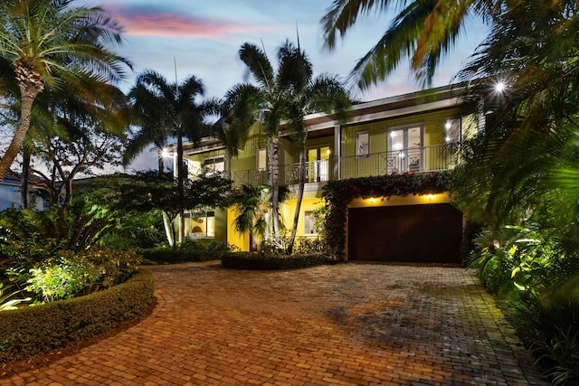 view of front facade with a balcony and a garage