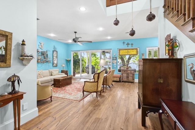 living room with ceiling fan and light hardwood / wood-style floors