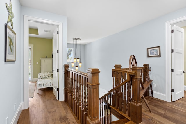 corridor with dark hardwood / wood-style flooring