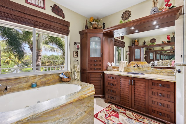 bathroom with tiled tub and vanity