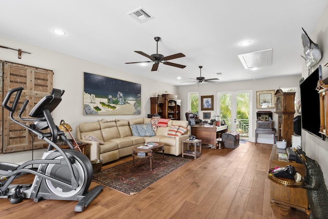 living room featuring hardwood / wood-style floors and ceiling fan