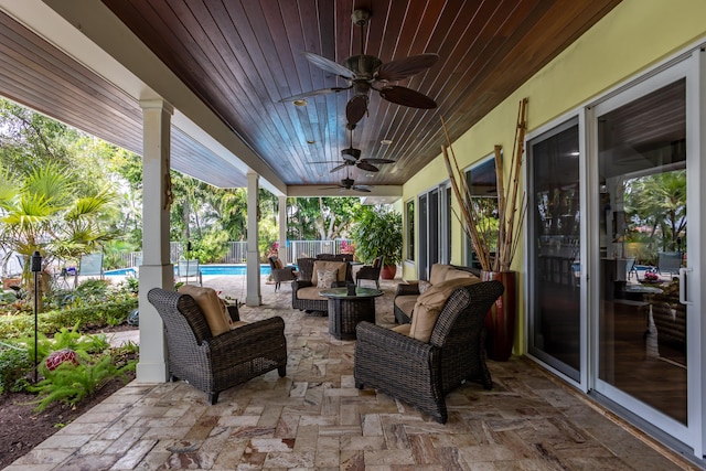 view of patio with outdoor lounge area and ceiling fan