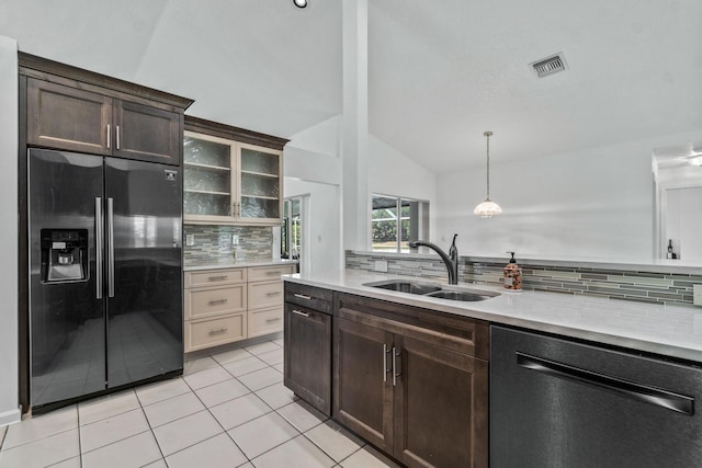 kitchen with backsplash, vaulted ceiling, black refrigerator with ice dispenser, sink, and dishwashing machine