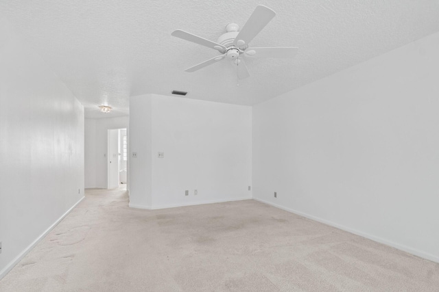 carpeted empty room with a textured ceiling and ceiling fan