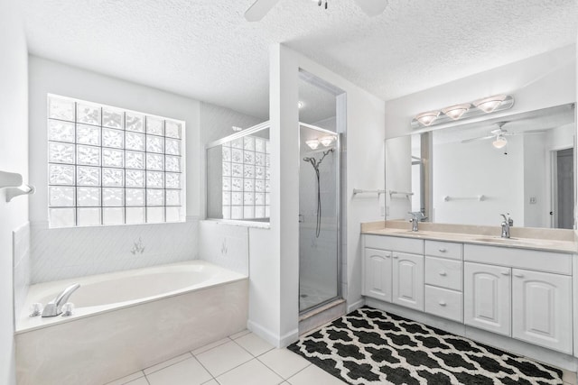 bathroom featuring ceiling fan, vanity, tile patterned floors, independent shower and bath, and a textured ceiling