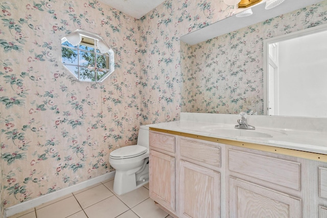 bathroom with toilet, vanity, and tile patterned flooring