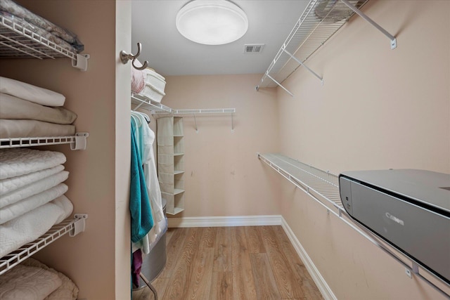 spacious closet featuring light wood-type flooring