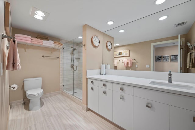 bathroom with tile flooring, vanity, an enclosed shower, and toilet