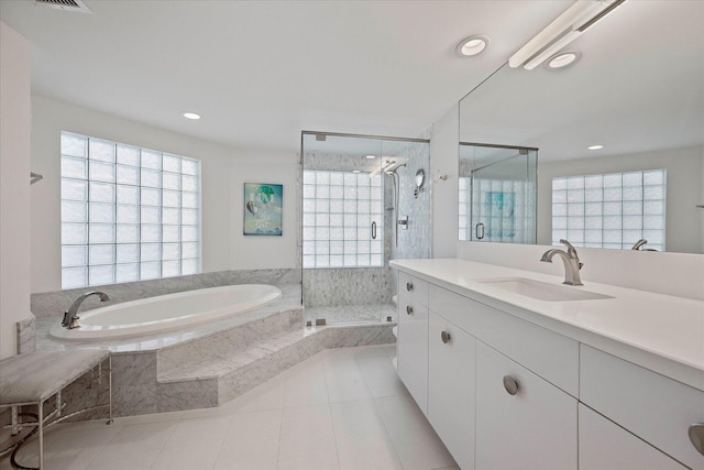 bathroom featuring tile flooring, vanity, and a wealth of natural light