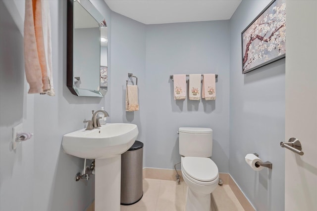 bathroom featuring toilet and tile flooring