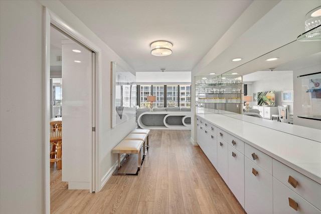 kitchen with white cabinets and light hardwood / wood-style floors