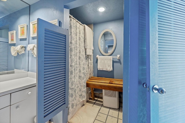 bathroom featuring vanity and tile flooring