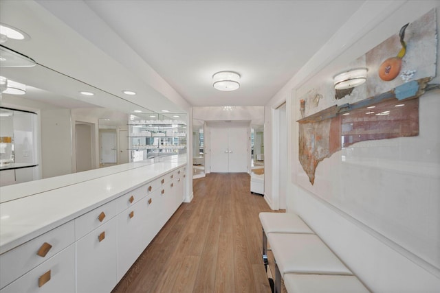 hallway with light hardwood / wood-style floors