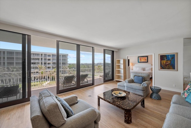 living room with expansive windows and light wood-type flooring