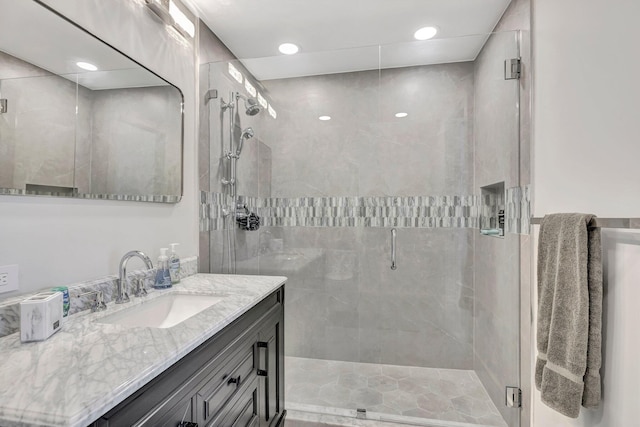 bathroom with vanity and a shower with shower door