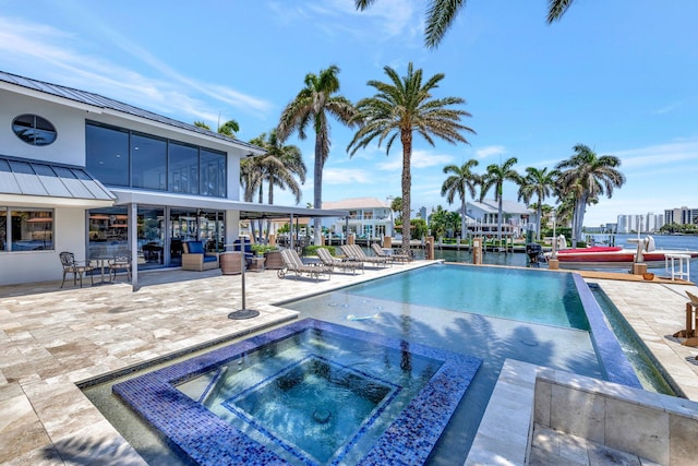 view of swimming pool featuring an in ground hot tub and a patio