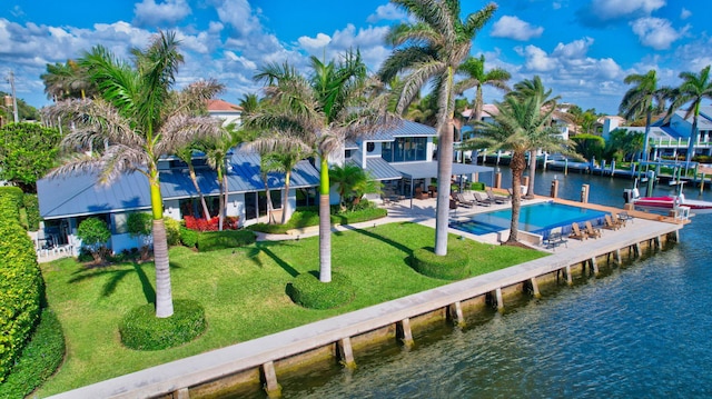 back of house featuring a yard, a water view, a patio area, and a community pool