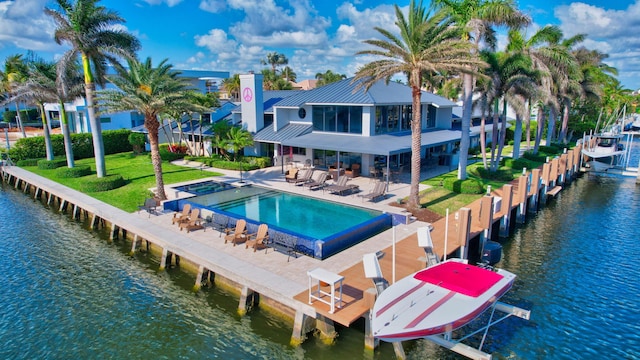 view of swimming pool featuring a boat dock, a water view, and a patio