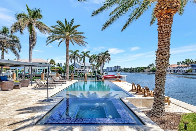 view of swimming pool with an in ground hot tub, a patio, and a water view