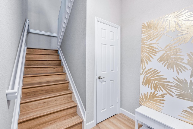 stairway featuring light hardwood / wood-style flooring