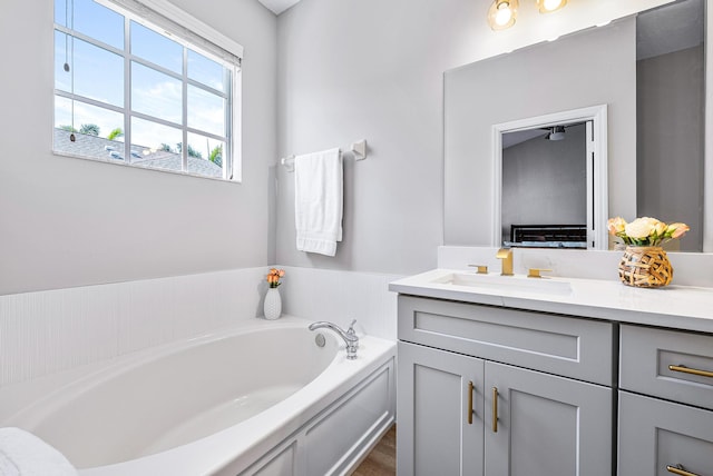 bathroom with vanity and a tub