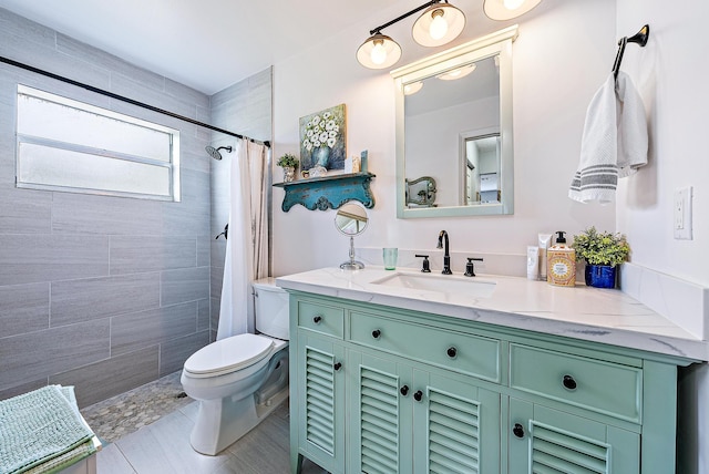 bathroom with tile flooring, vanity, toilet, and a shower with shower curtain