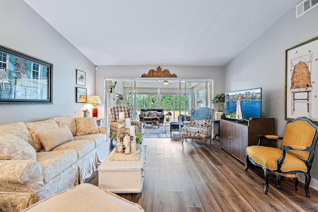 living room with a textured ceiling and hardwood / wood-style floors