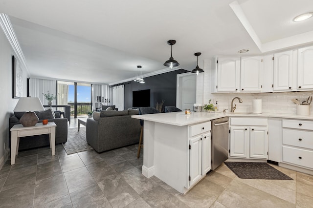 kitchen featuring white cabinets, sink, stainless steel dishwasher, hanging light fixtures, and ornamental molding