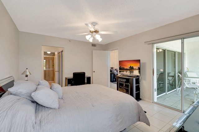 bedroom with ceiling fan, light tile patterned floors, a textured ceiling, and access to outside