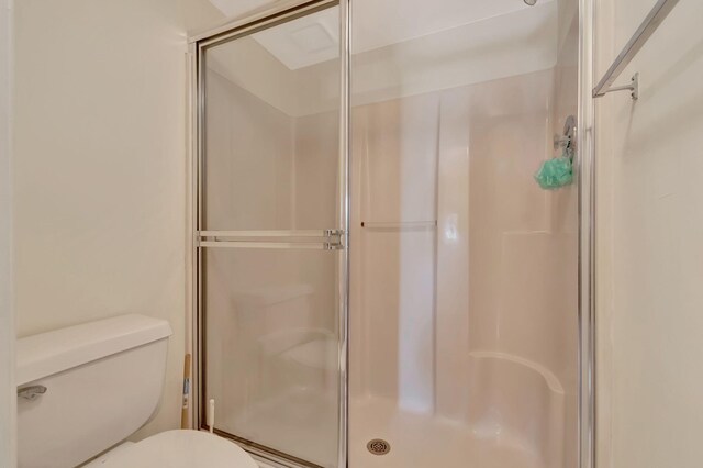 bathroom featuring toilet and walk in shower