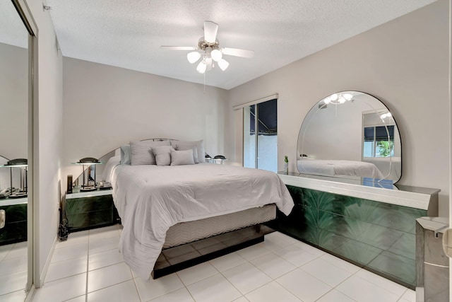 tiled bedroom with access to exterior, ceiling fan, and a textured ceiling