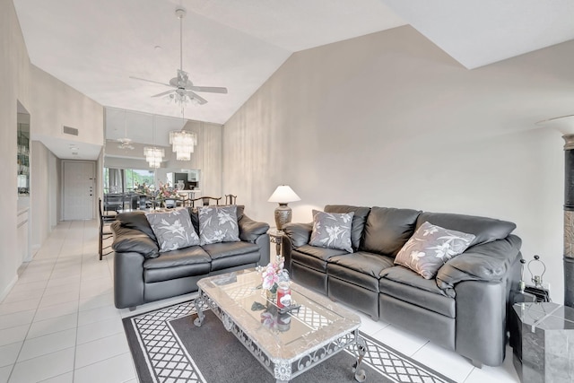 living room with ceiling fan with notable chandelier, light tile patterned floors, and high vaulted ceiling