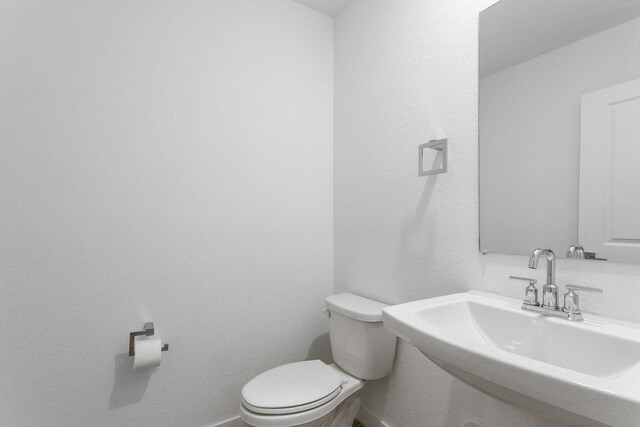 bathroom with toilet and sink