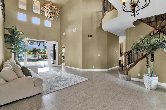 tiled living room featuring a chandelier and a high ceiling