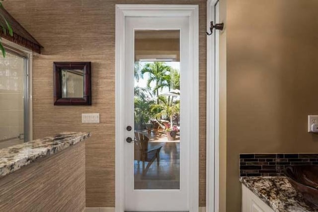 doorway to outside featuring sink