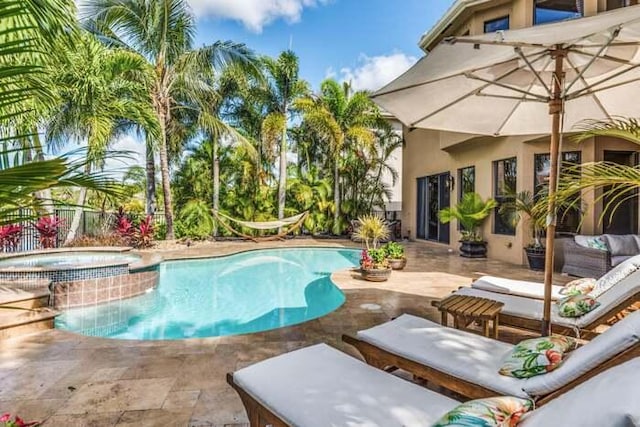 view of pool featuring outdoor lounge area, an in ground hot tub, and a patio