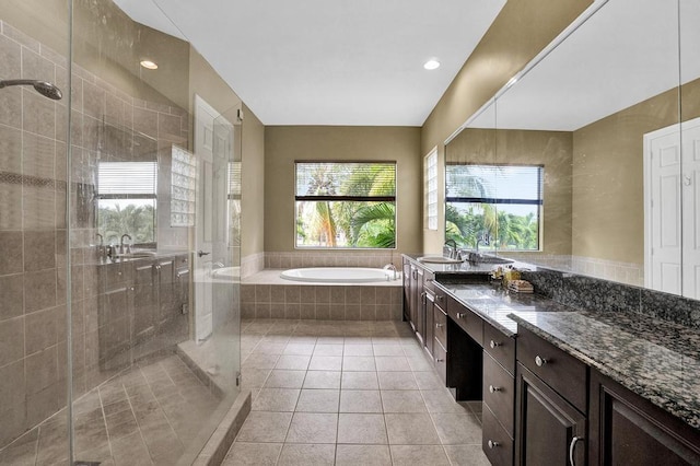 bathroom with tile patterned floors, separate shower and tub, and a healthy amount of sunlight