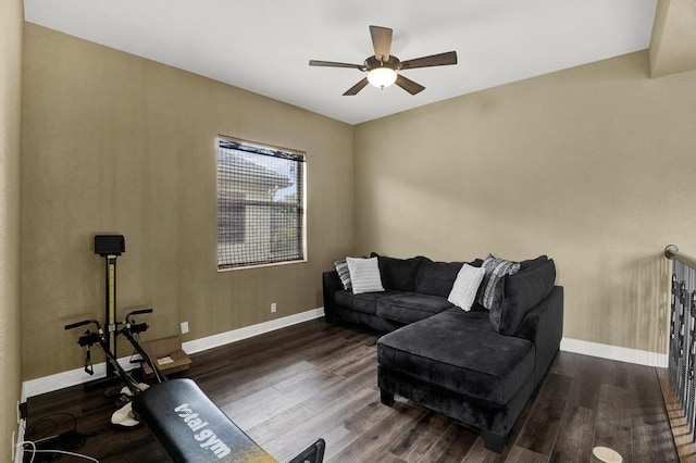 living room with dark hardwood / wood-style flooring and ceiling fan