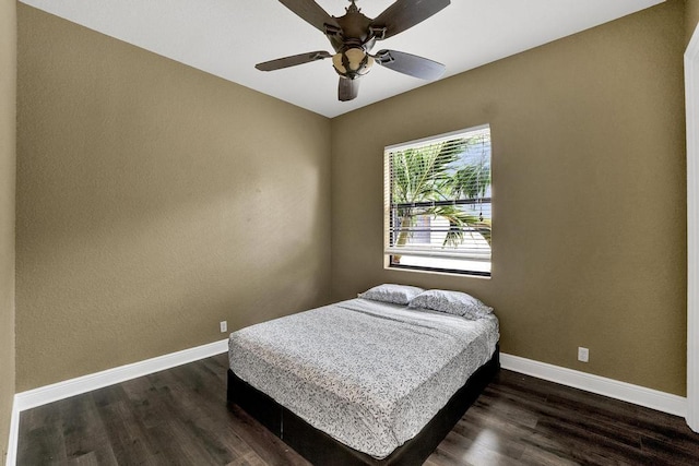 bedroom with ceiling fan and dark wood-type flooring