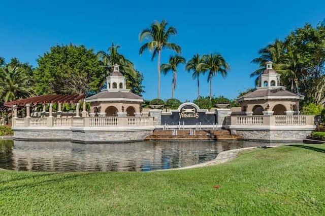 view of home's community with a gazebo, a water view, and a yard