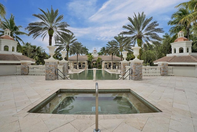 view of swimming pool with an in ground hot tub and a patio