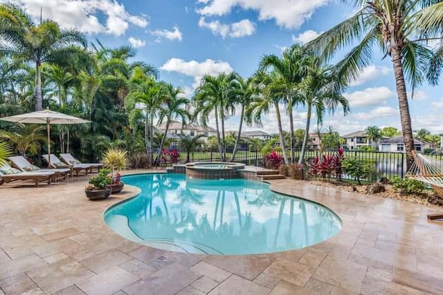 view of pool with an in ground hot tub and a patio