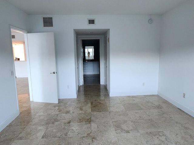 unfurnished room with tile flooring