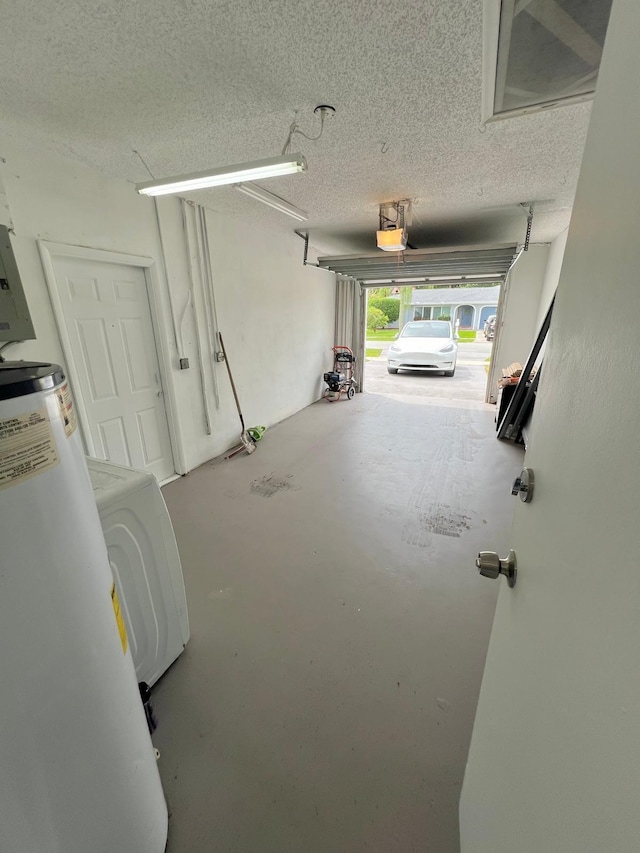 garage featuring a garage door opener and washer / dryer