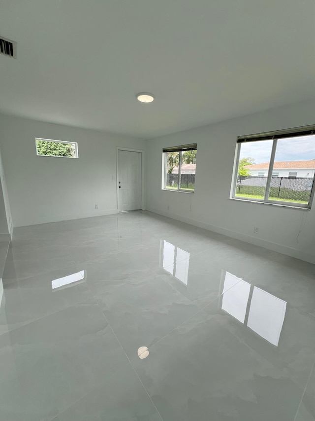 unfurnished room with light tile patterned floors