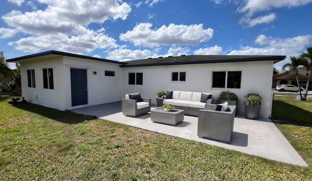 back of house featuring a lawn, an outdoor hangout area, and a patio area