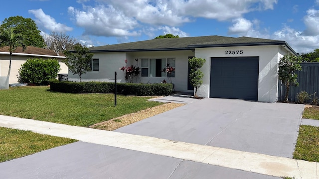 ranch-style house featuring a garage and a front lawn