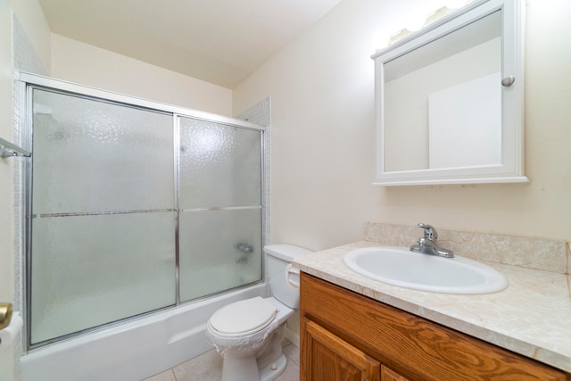 full bathroom featuring large vanity, tile floors, toilet, and enclosed tub / shower combo