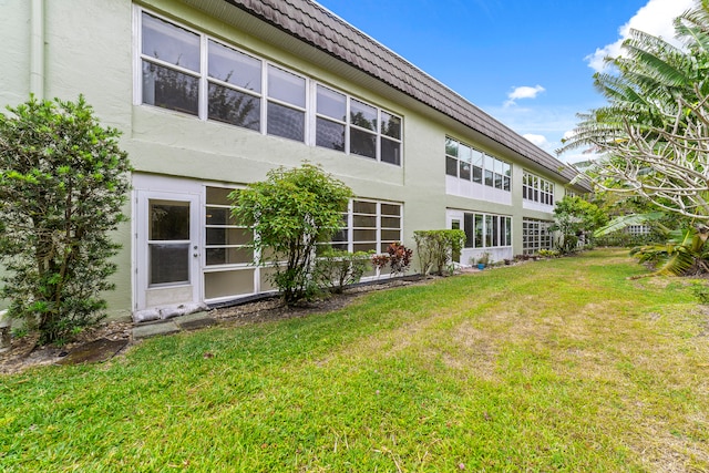 back of house with a lawn